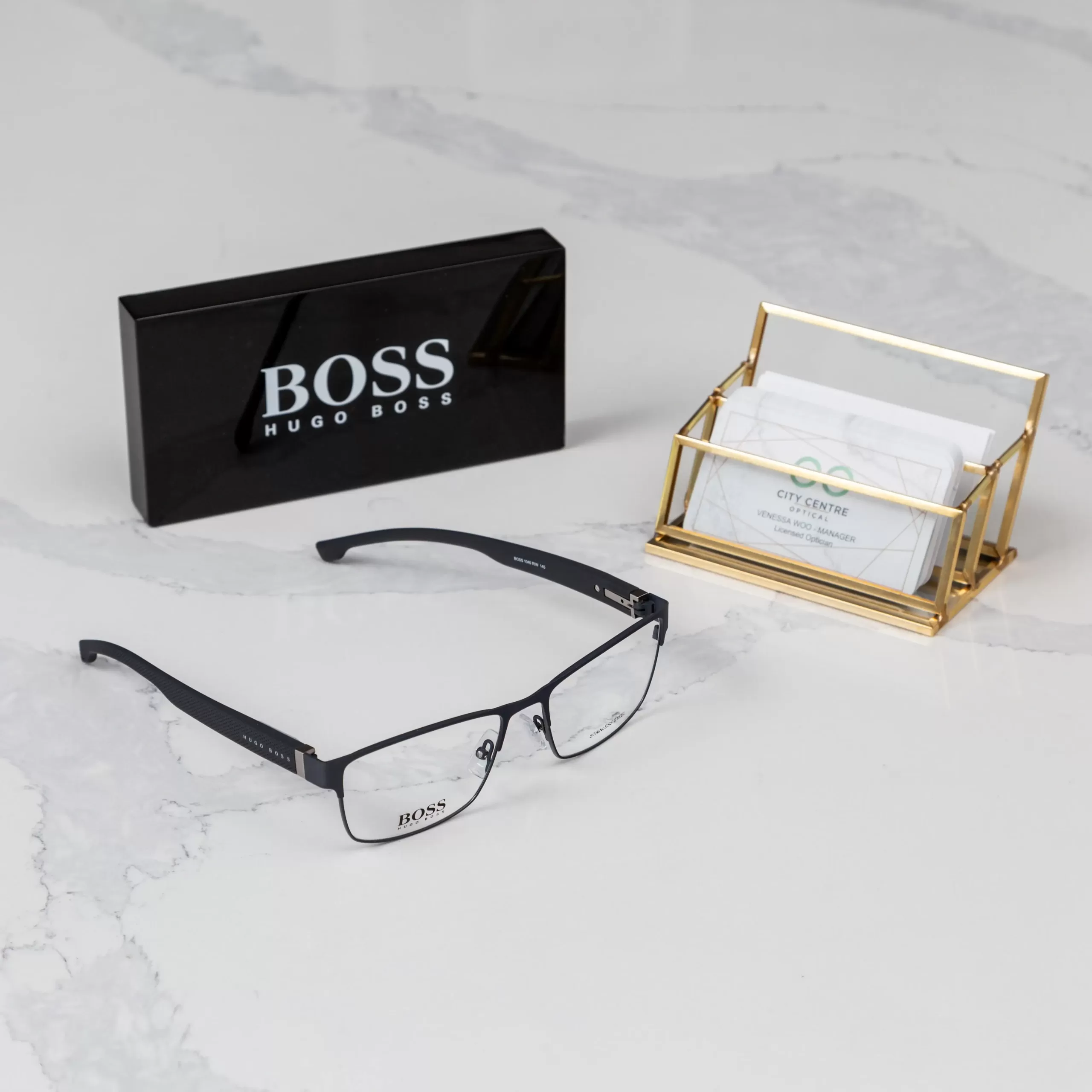 pair of Boss glasses placed beside stack of City Centre Optical - Surrey, B.C. cards